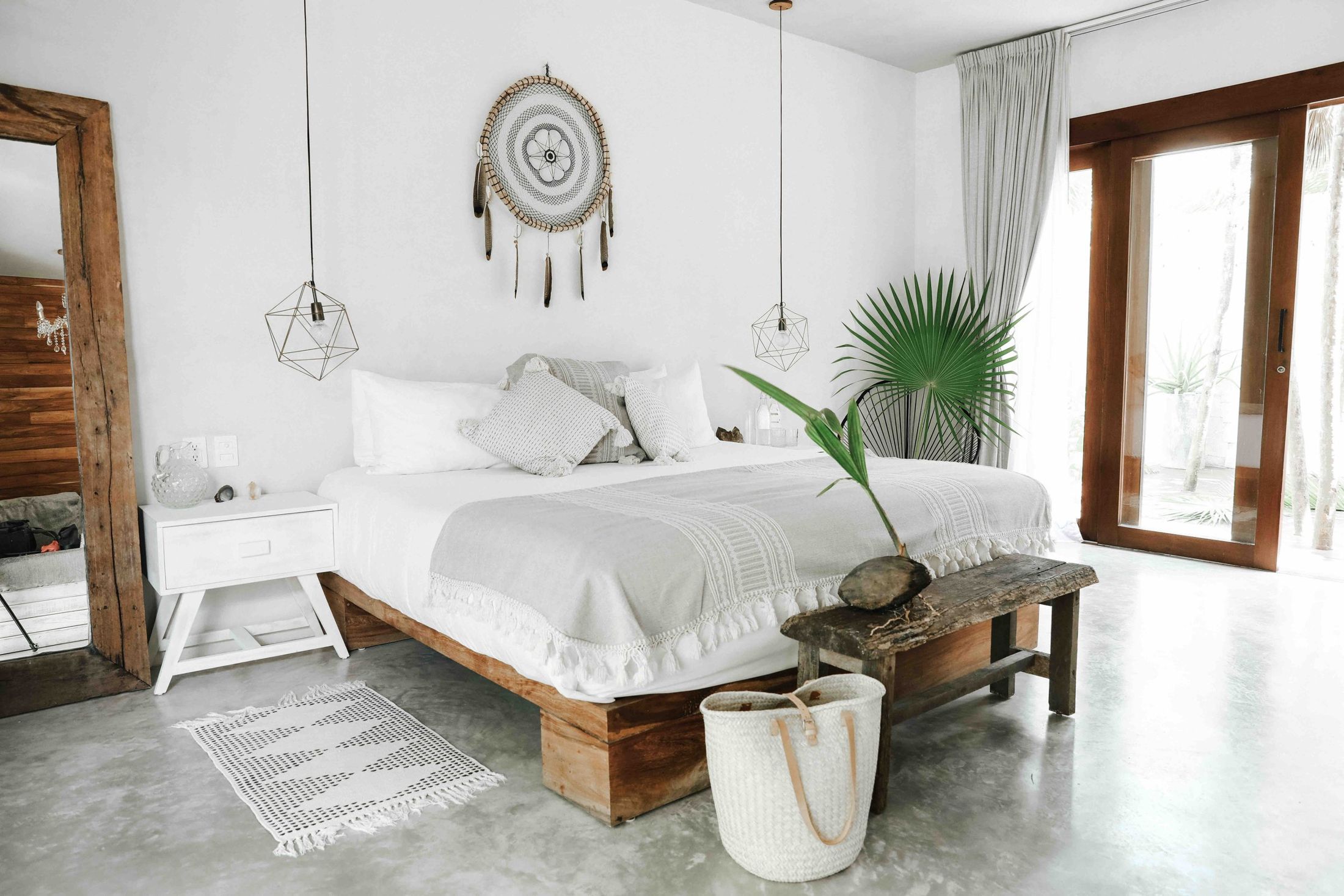 A Sanará bedroom: white linen, timber doors open to the garden