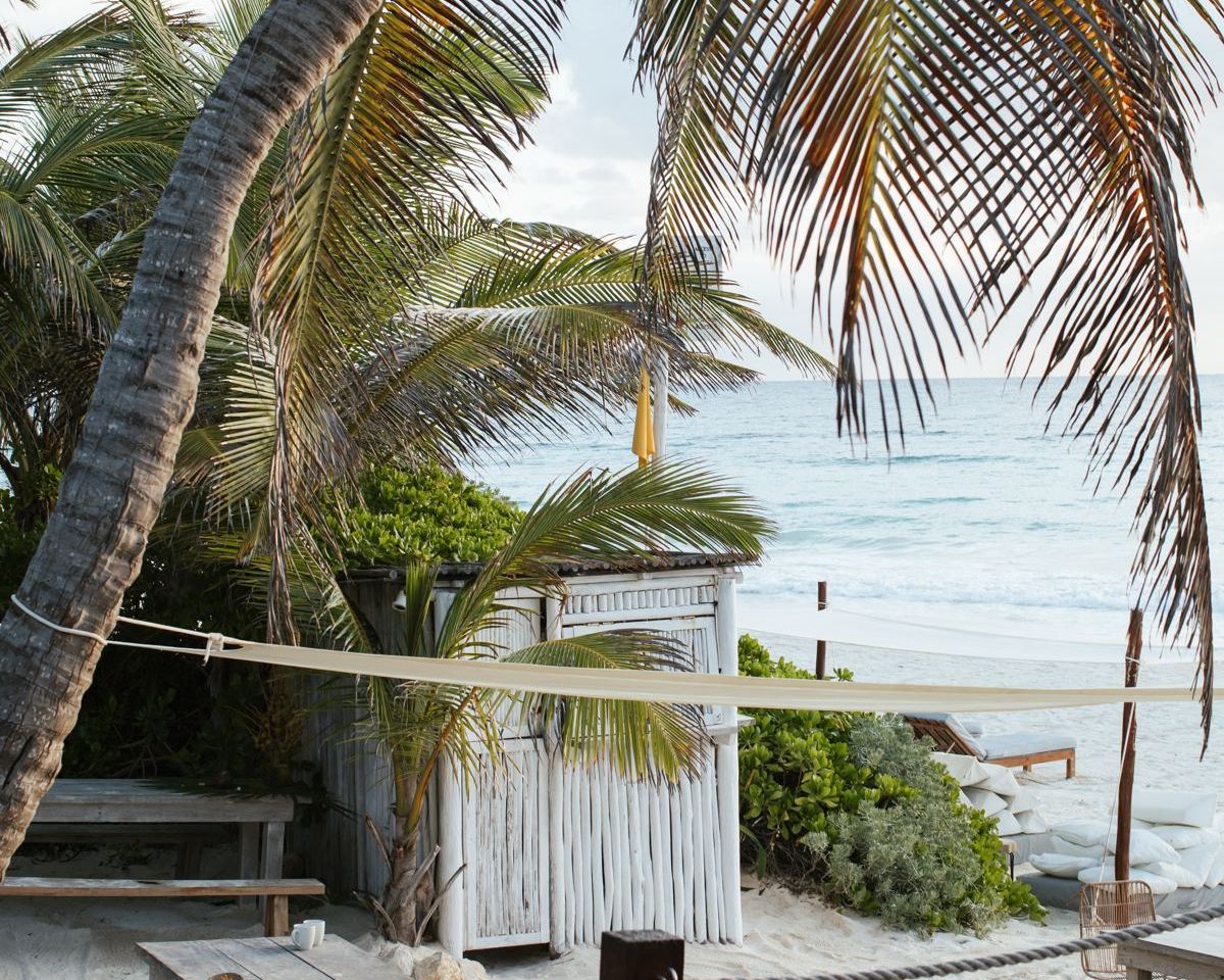 The beach deck at Sanará, tables under the palms